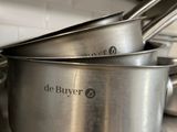 pots and pans stacked on top of each other in a kitchen