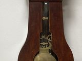 a grandfather clock sitting on the floor next to a basket