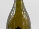 bottle of wine with a label on it sitting on a white surface