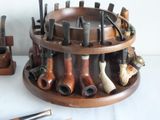 a lot of pipe holders on a table with a lot of pipe holders