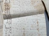 an old letter is sitting on top of a piece of paper
