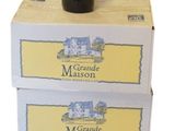 boxes of wine are stacked on top of each other with a bottle of wine