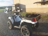 a white and black atv parked on the side of the road