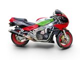 a red and green motorcycle parked on a white surface