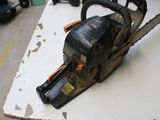 a chainsaw sitting on top of a cardboard box on a table
