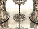 a silver candle holder with two candles on it