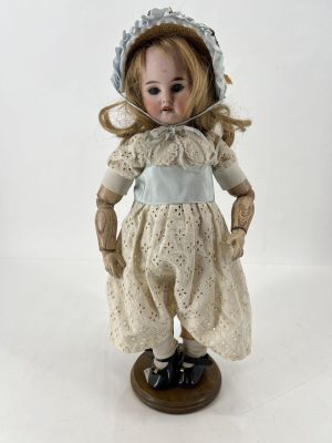 un gros plan d'une poupée portant un chapeau et une robe