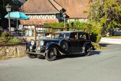 a vintage car that is parked on the side of the road