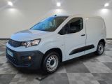 a white van is parked in a room with checkered flooring