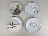 three plates with blue and white designs on them sitting on a table
