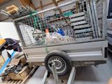 a silver truck with a cage on the back of it