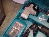 a blue box with a drill and a charger in it