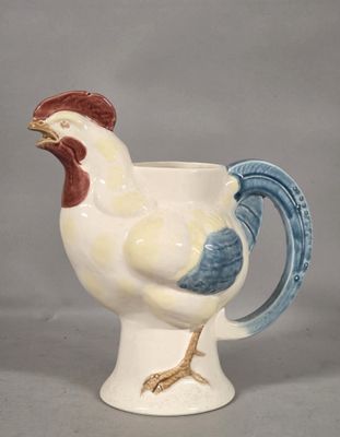 a white and blue mug with a rooster on it