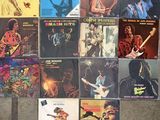 several different records are stacked on top of each other on the floor