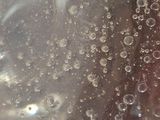 a close up of a glass of soda with bubbles