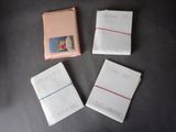 four pieces of paper with writing on them sitting on a table