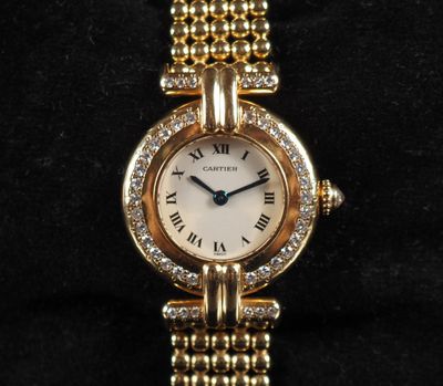 a close up of a gold watch with diamonds on it