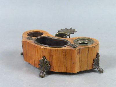 a small wooden box with two candles inside of it