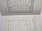 an open book with a drawing of a plan of a building and a plan of a floor plan
