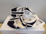 pair of black and white shoes on a white box on a table