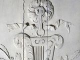a white wall with a decorative design on it