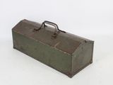 an old metal tool box sitting on top of a white surface