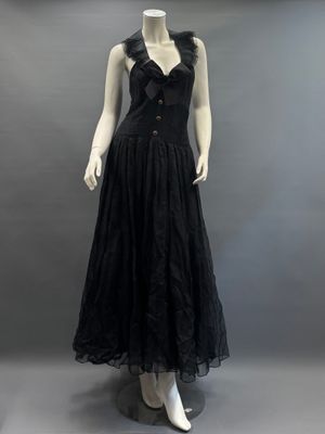 an image of a mannequin wearing a black dress on a mannequin stand