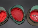 three hats are lined up on top of each other on a table
