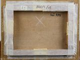 an old picture of a picture frame on a table with a piece of paper taped around it
