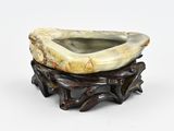 a small bowl that is sitting on a wooden stand
