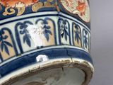 a close up of a vase with flowers on it