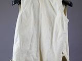 the back of a white shirt hanging on a black hanger