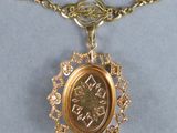 gold plated necklace with a coin in the center and a chain around it