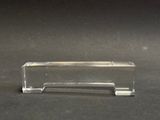 a small clear piece of glass on a black surface