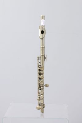 an image of a silver flute on a clear stand on a white background