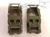 two army green toy cars sitting next to each other on a table
