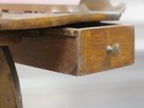 a close up of a wooden table with a drawer on it