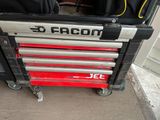 a red tool box with a black and silver sign on it