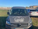 La camionnette est garée sur l'herbe, devant une clôture.