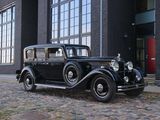 a old black car parked in front of a building