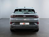 the rear end of a grey volkswagen suv in a white room