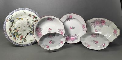 several plates and bowls sitting on a table with a gray background