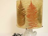 a lamp that is sitting on a table with a lamp shade on it