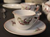 a lot of cups and saucers on the table