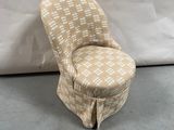 an upholstered chair with a checkered upholstered seat