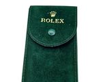 a close up of a green case with a rolex logo on it