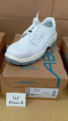 a pair of white shoes sitting on top of a box