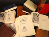 several books are sitting on a table next to each other