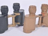 several different types of binoculars are lined up on a white surface