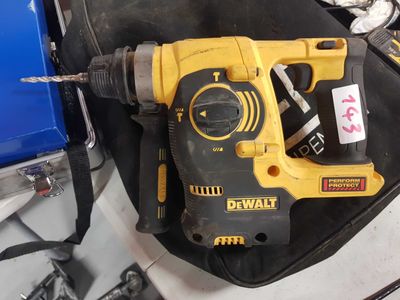 a corded drill sitting on top of a black bag